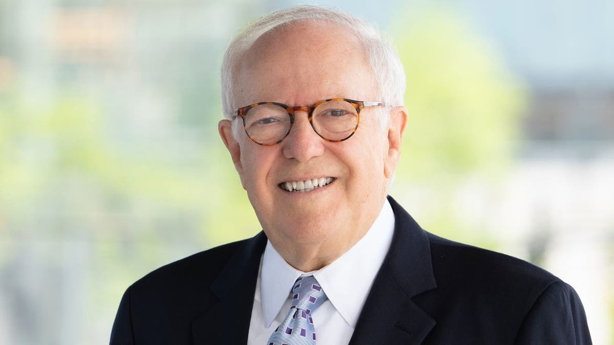 Washington lawyer Robert Barnett wearing a suit and glasses, smiling in a portrait.