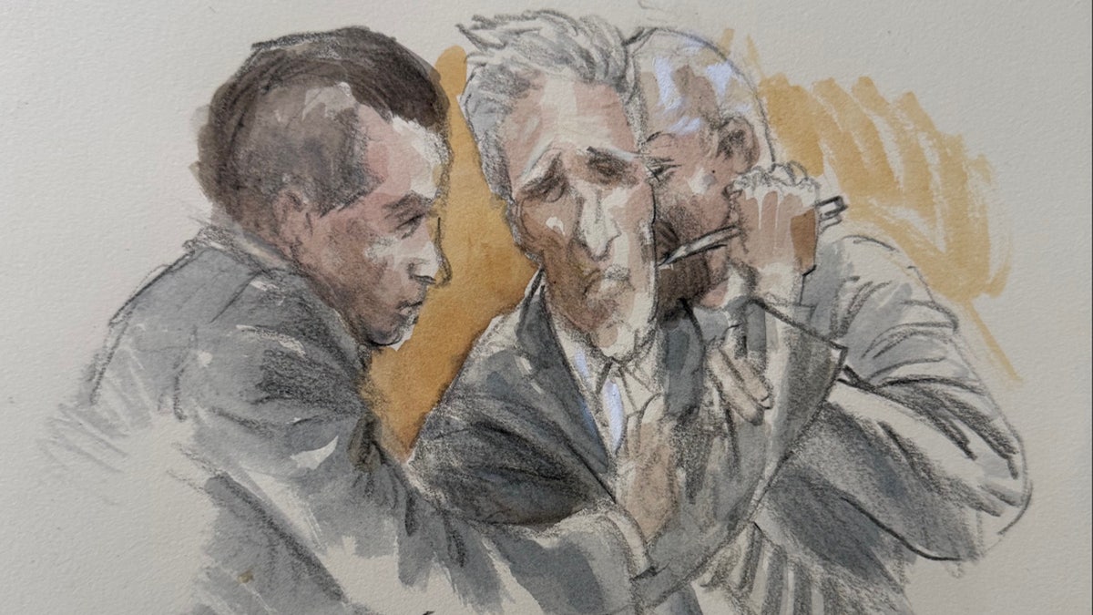 Routh holding a pen to his neck in court