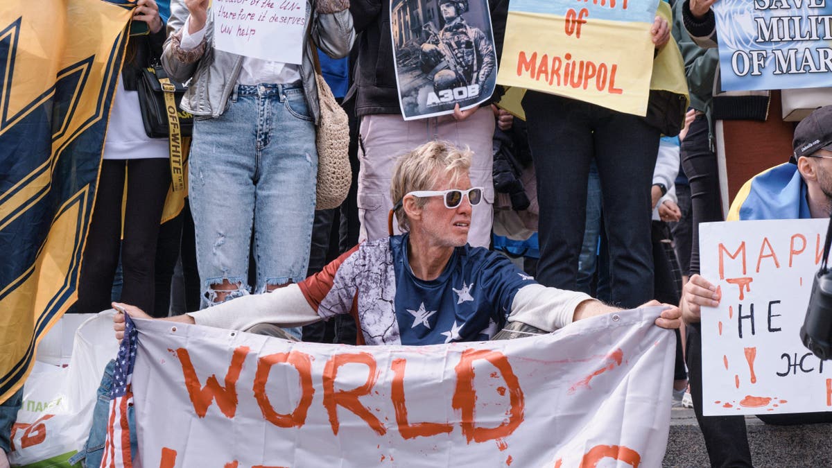 Ryan Routh is seen in May, 2022 holding a banner stating 'World Help Us' during a demonstration in in Kyiv, Ukraine. (Artem Gvozdkov/Global Images Ukraine via Getty Images)