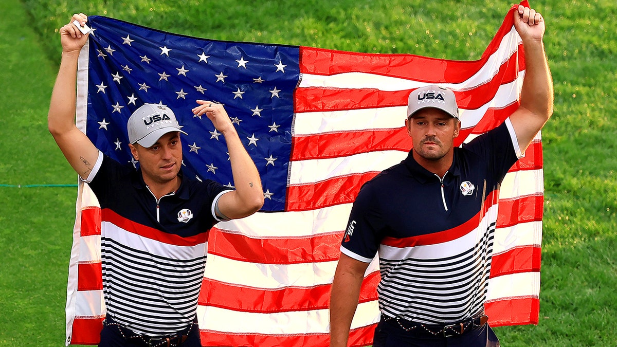Justin Thomas and Bryson DeChambeau hold American Flag at Ryder Cup