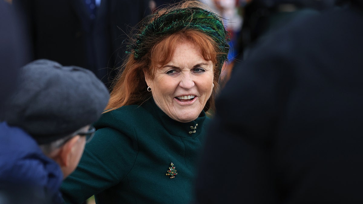 Sarah Ferguson smiling and wearing a green coat with a matching headband during Christmas mass.