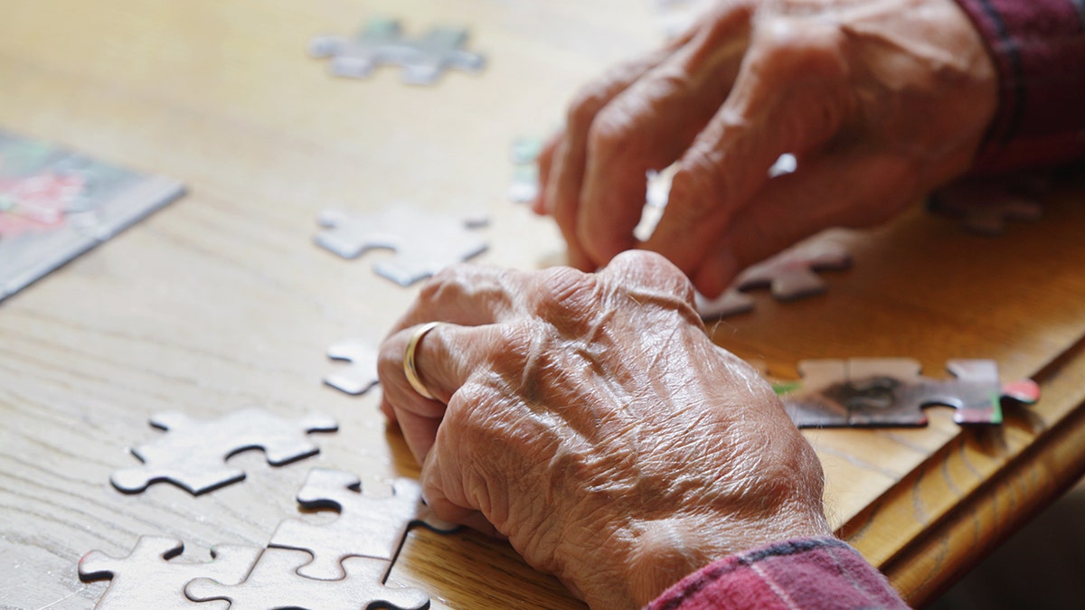 senior man doing a puzzle
