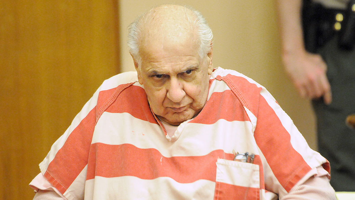 Serial killer Joseph Naso where a striped orange and white jumpsuit looking sinister in court.