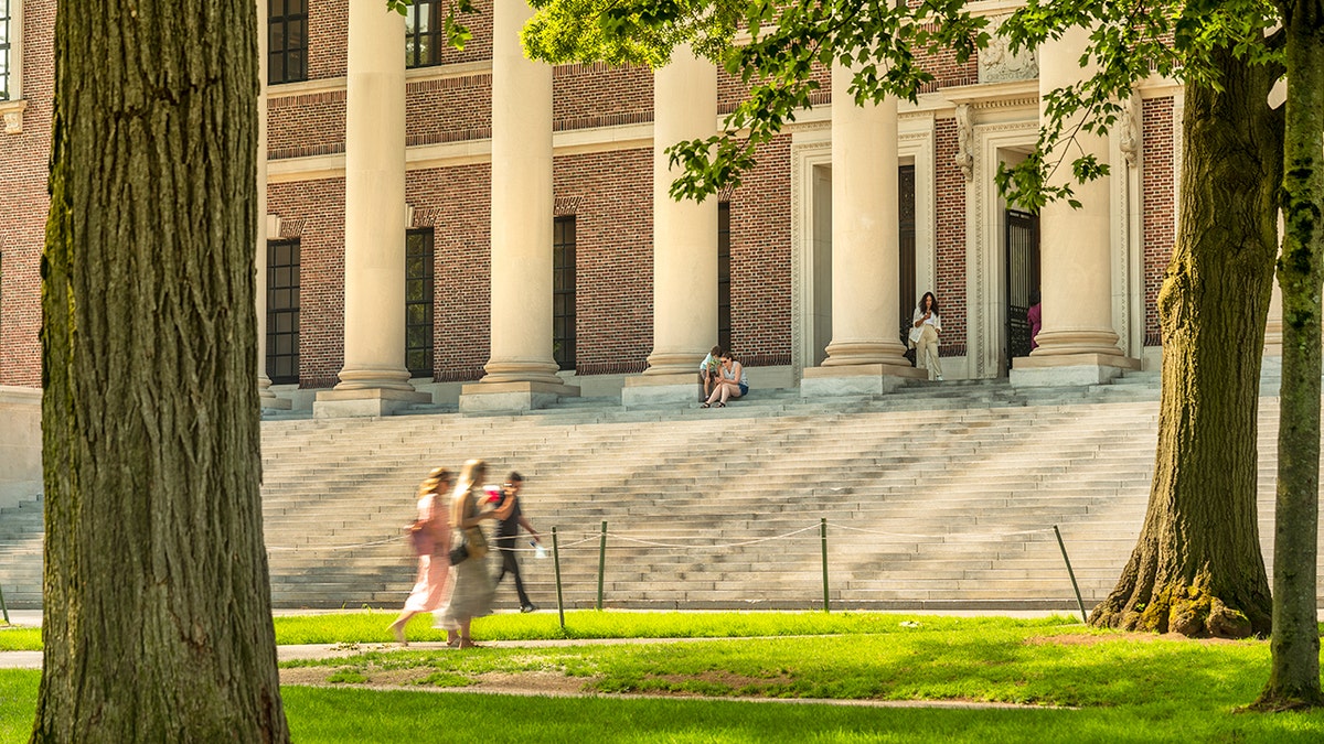 Students walking in the middle of a college campus