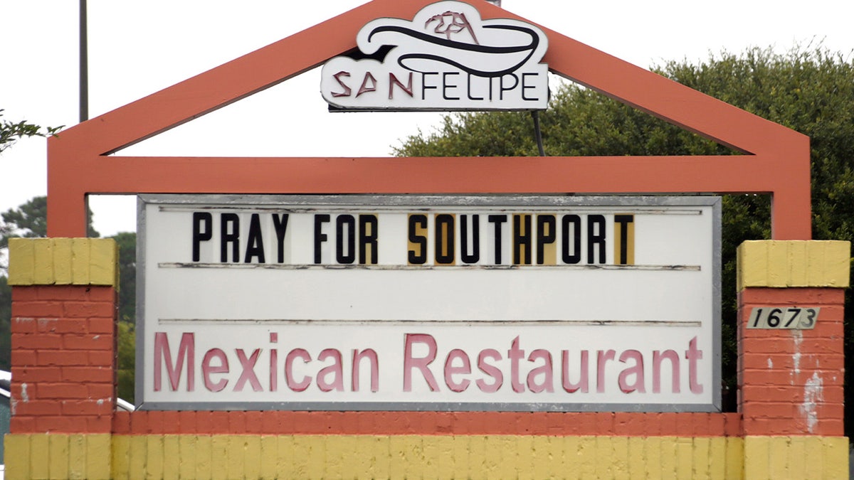 A sign on a Mexican restaurant asks people to "Pray for Southport"