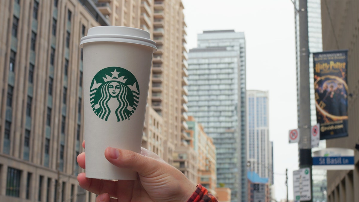 Hand holding Starbucks hot tea
