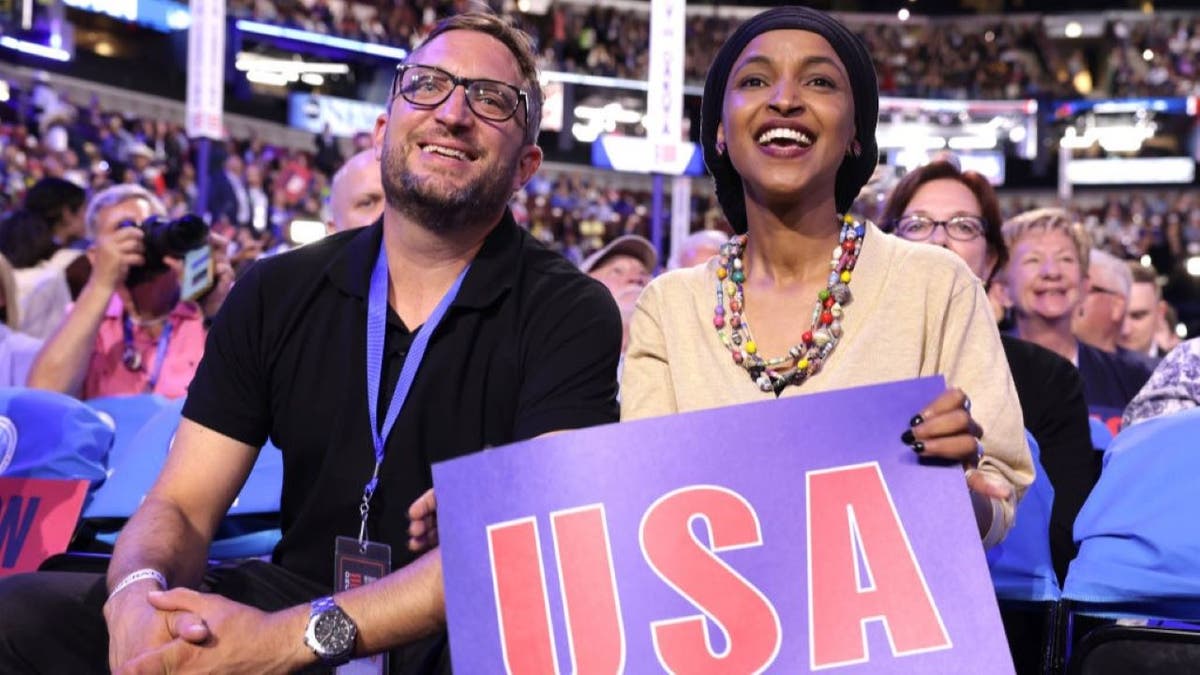Representative Ilhan Omar (D-MN) sits with her husband Tim Mynett on the first day of the National Democratic Convention at the United Center on August 19, 2024 in Chicago, Illinois.
