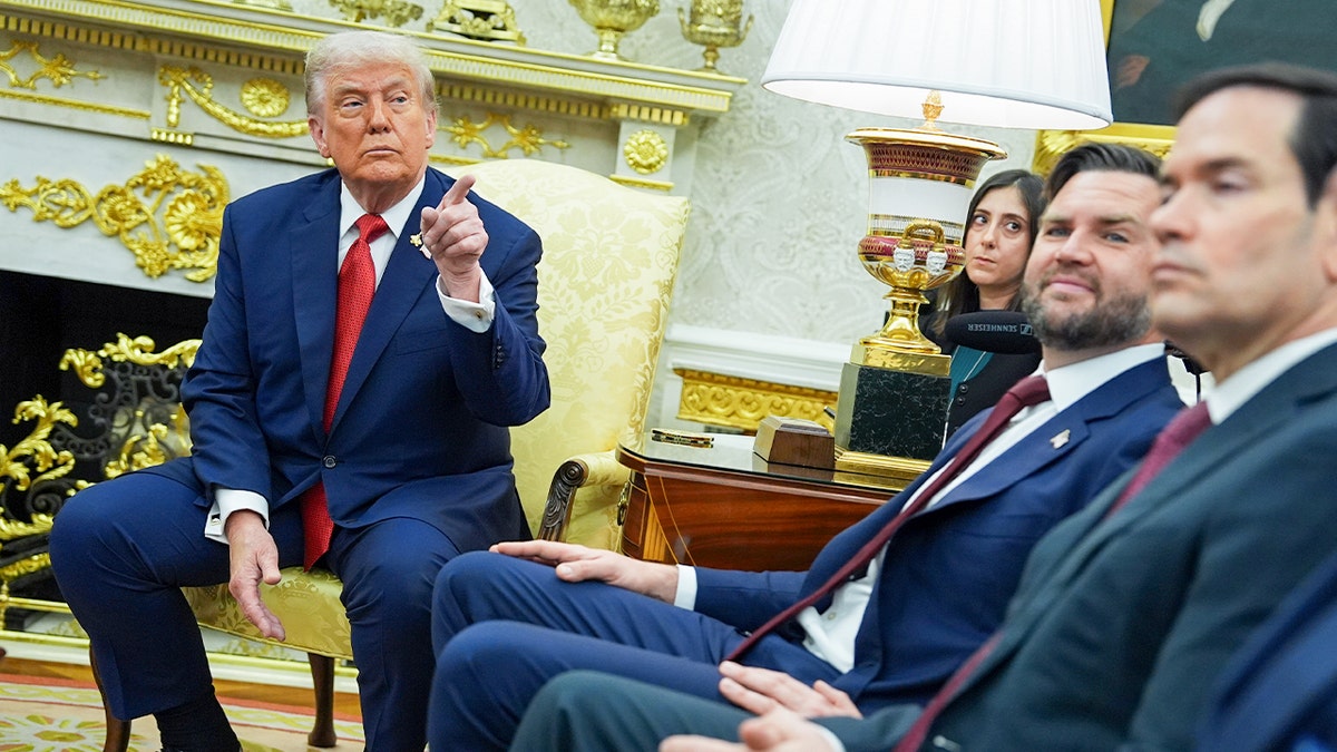 President Donald Trump gestures while speaking in the Oval Office