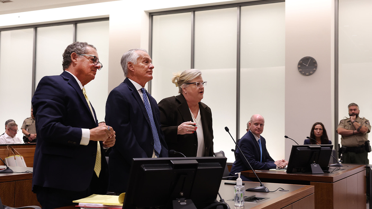 Tyler Robinson's attorneys standing together as they greet the court during a hearing without him present