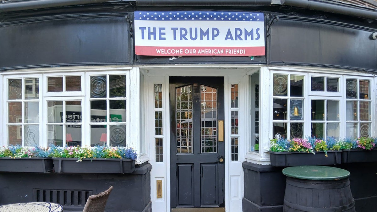 Trump arms signature outside the bar