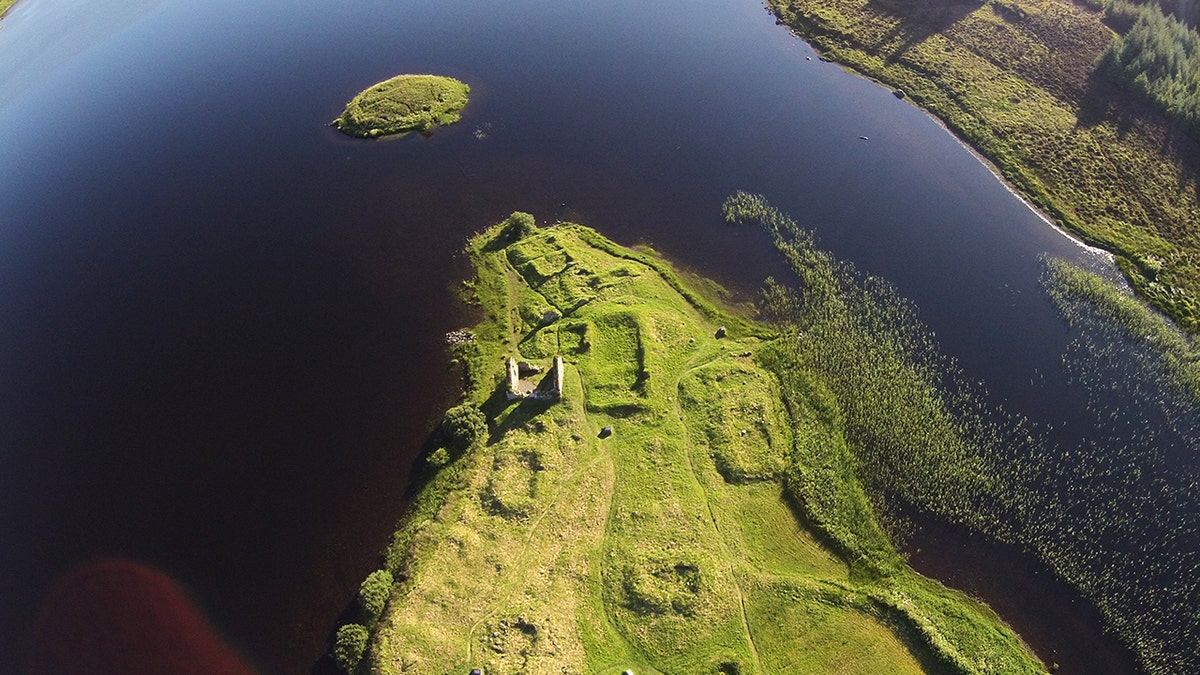 Aerial of scottish island, castle remains