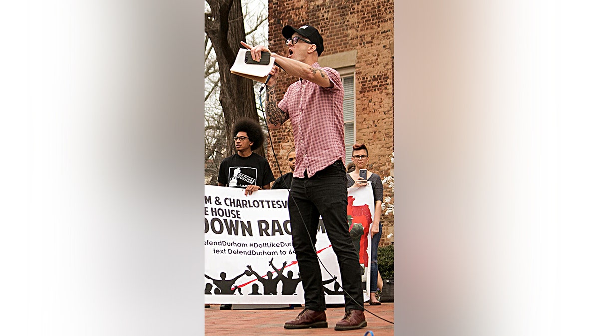 Left wing activist professor and Redneck Revolt Gun Club member Dwayne Dixon yells into a microphone