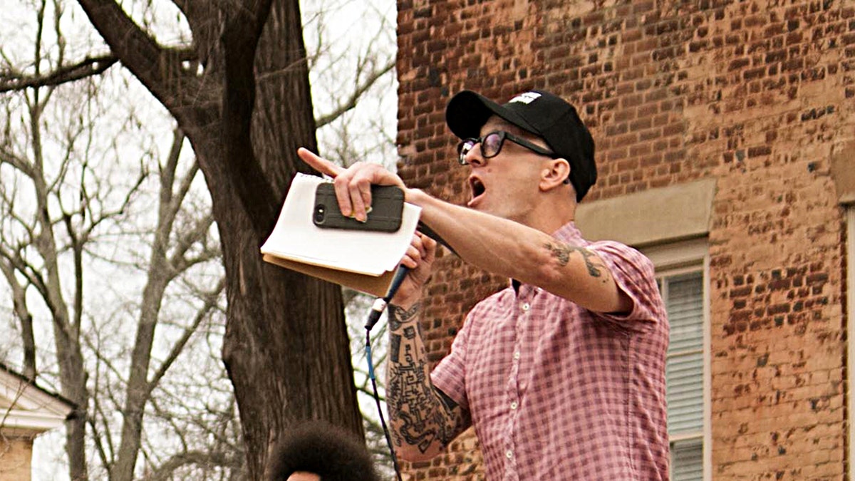 Left wing activist professor and Redneck Revolt Gun Club member Dwayne Dixon yells into a microphone