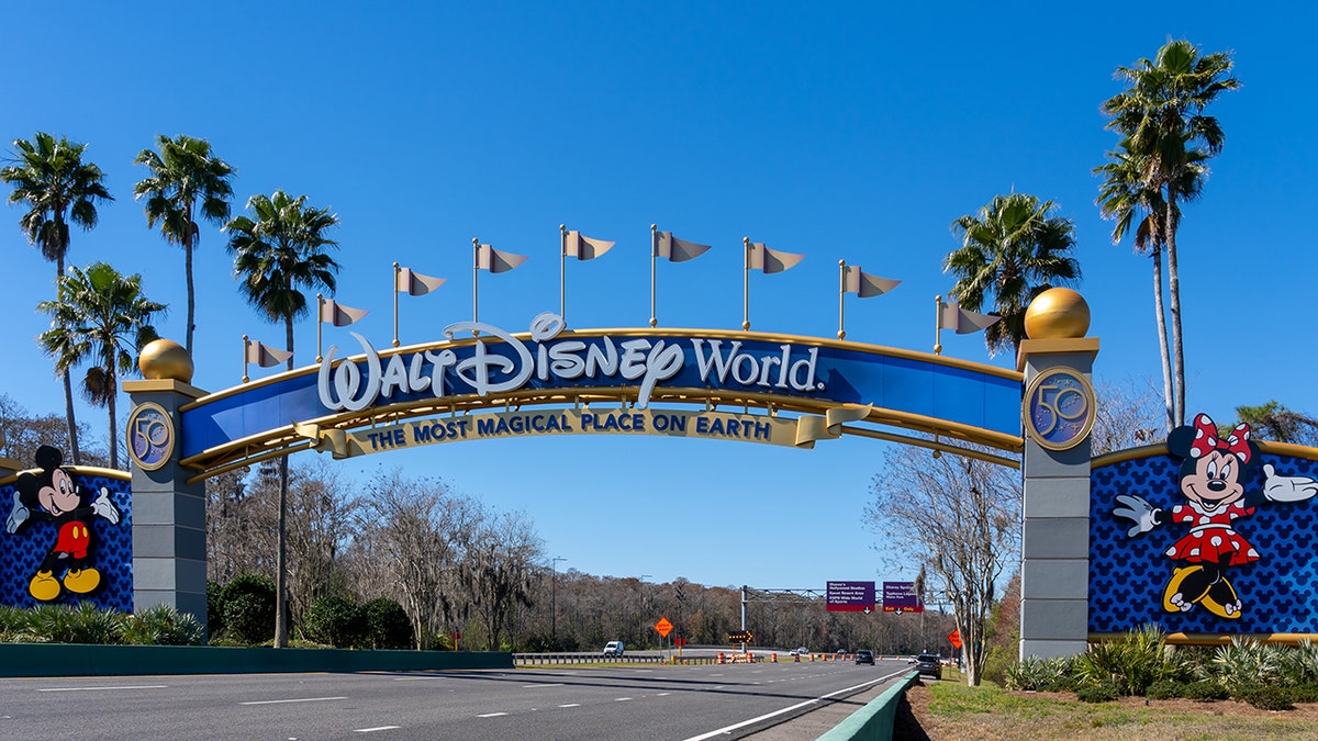 Orlando, Florida road leading to Walt Disney World with arches overhead to welcome.