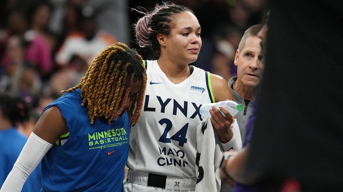Napheesa Collier is helped off the court