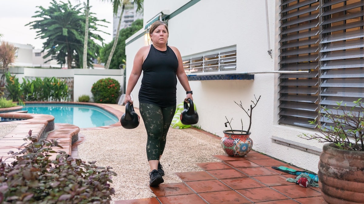 Woman carrying kettlebells