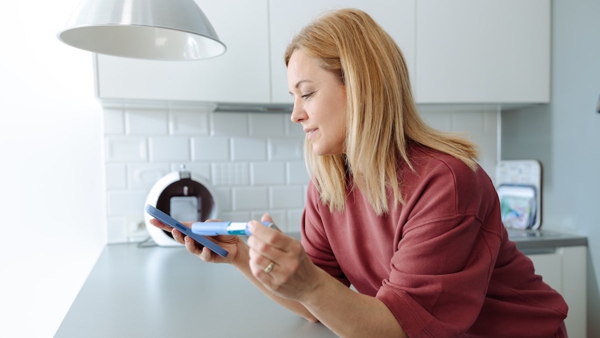 Woman holding GLP-1 medication