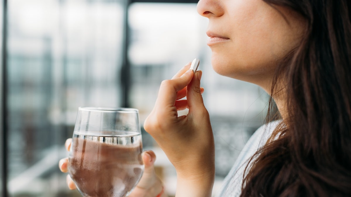 Woman taking pill