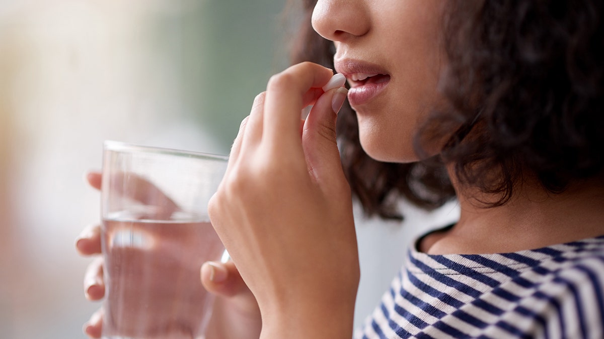 woman taking a pill