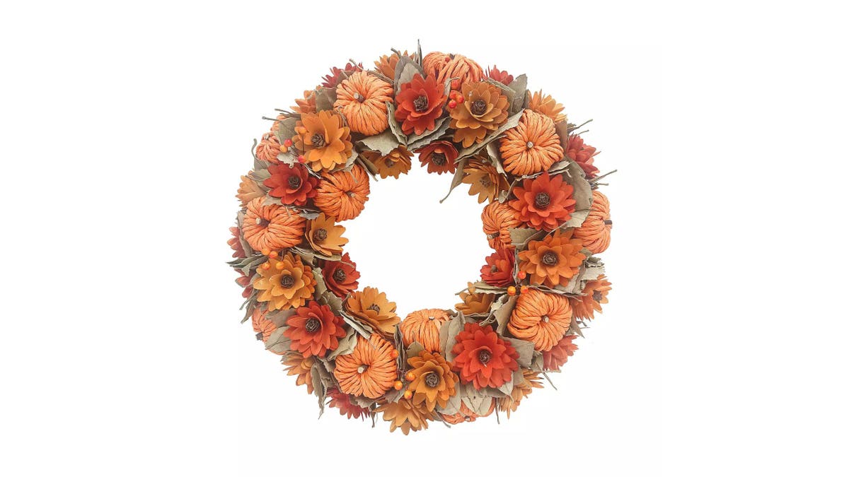 This seasonal wreath is decorated with pumpkins.