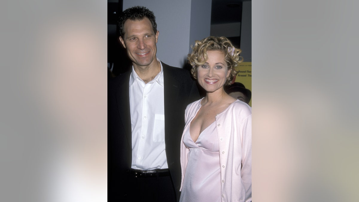 Maureen McCormick smiling next to her husband Michael Cummings.