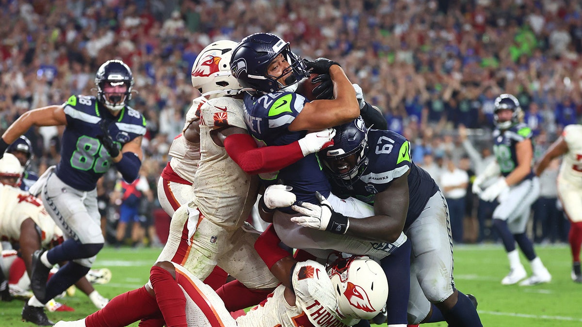 Zach Charbonnet fights for touchdown