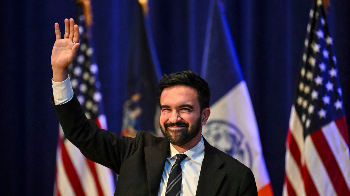 New York City Mayoral candidate Zohran Mamdani waves during a town hall