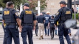 Law enforcement personnel responding at the scene of a shooting at an ICE field office in Dallas