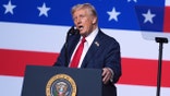 Donald Trump speaking to military senior leaders with American flag backdrop