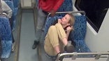 Iryna Zarutska cowering in her seat on a Charlotte commuter train as attacker towers over her