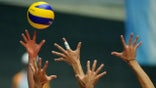 Volleyball players fight for ball