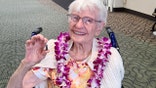 World War II Navy nurse Alice Beck Darrow smiling into camera, wearing a pink lei