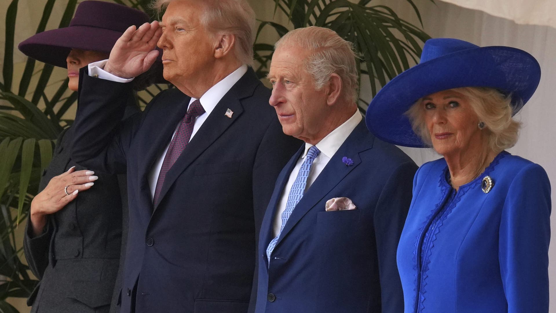 President Donald Trump salutes alongside King Charles III and Queen Camilla, with Melania Trump on the left, as they listen to the national anthem at Windsor Castle on September 17, 2025.