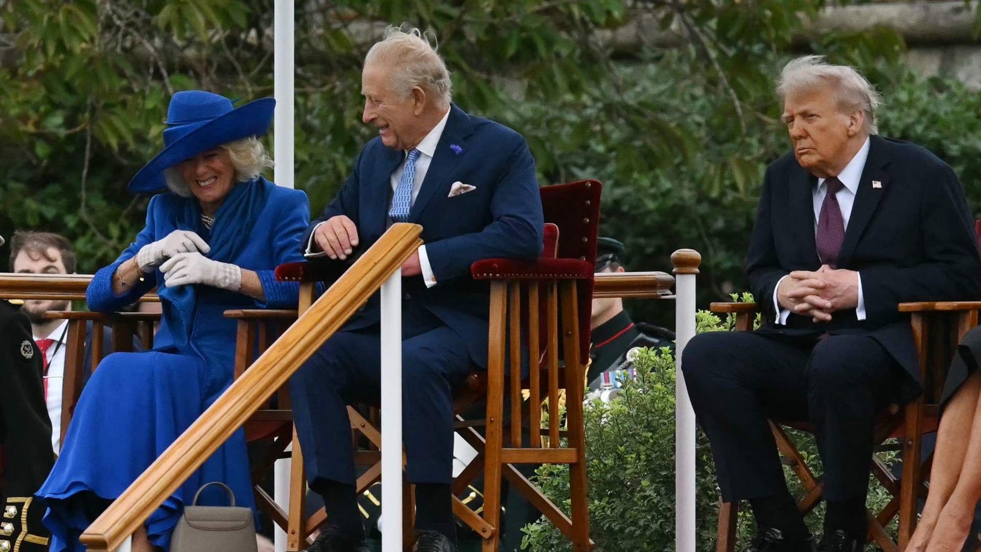 Queen Camilla laughs warmly while sitting next to King Charles and Donald Trump at Windsor Castle’s ceremony.