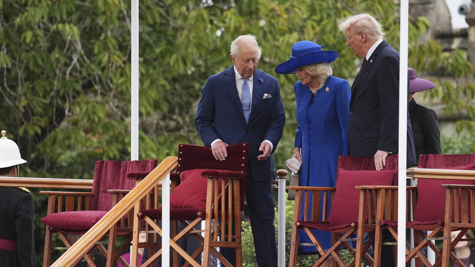 King Charles III, Queen Camilla, Donald Trump, and first lady Melania Trump rise from their seats as the ceremony continues.