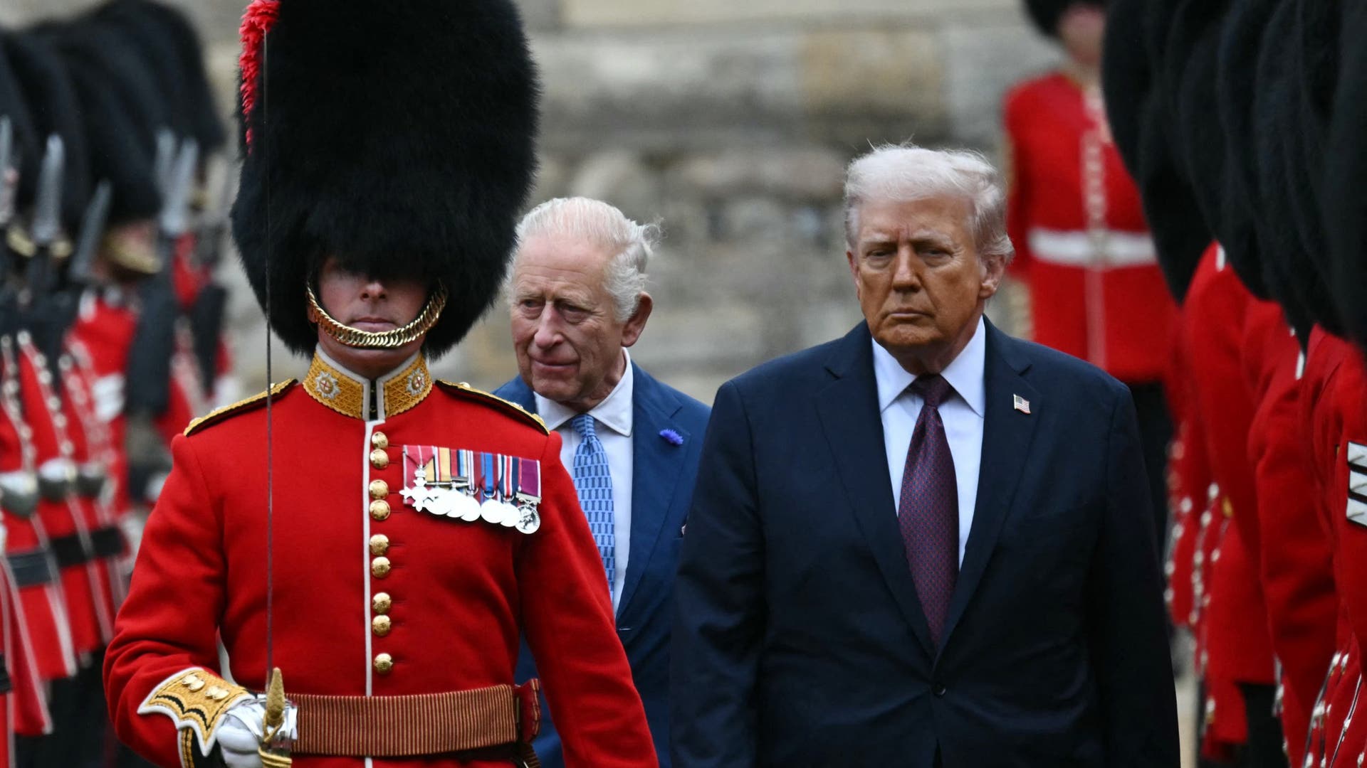 King Charles III and US President Donald Trump, led by a Coldstream Guardsman, inspect the Guard of Honour during a ceremonial welcome at Windsor Castle.