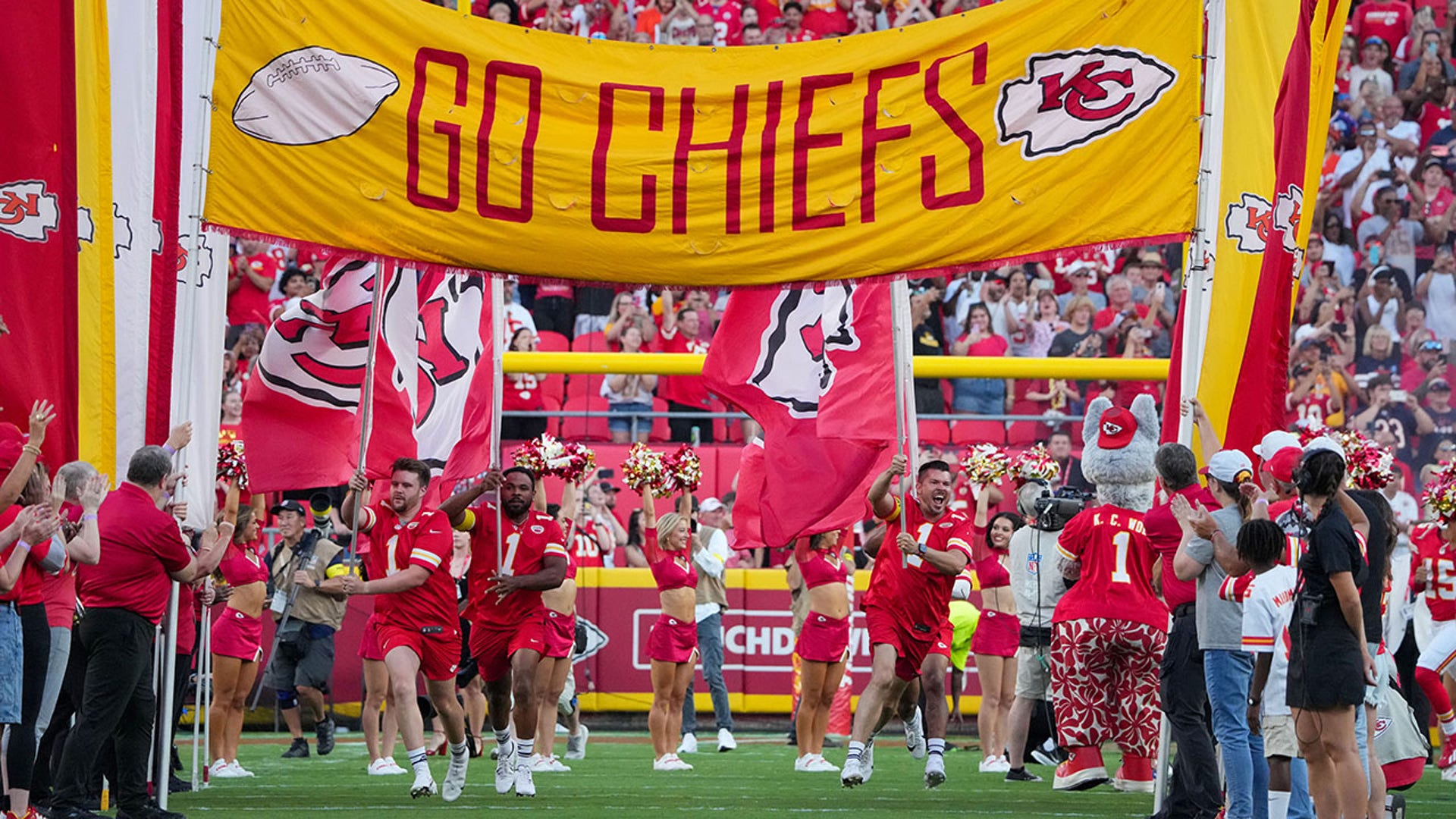 Cheerleaders run onto the field
