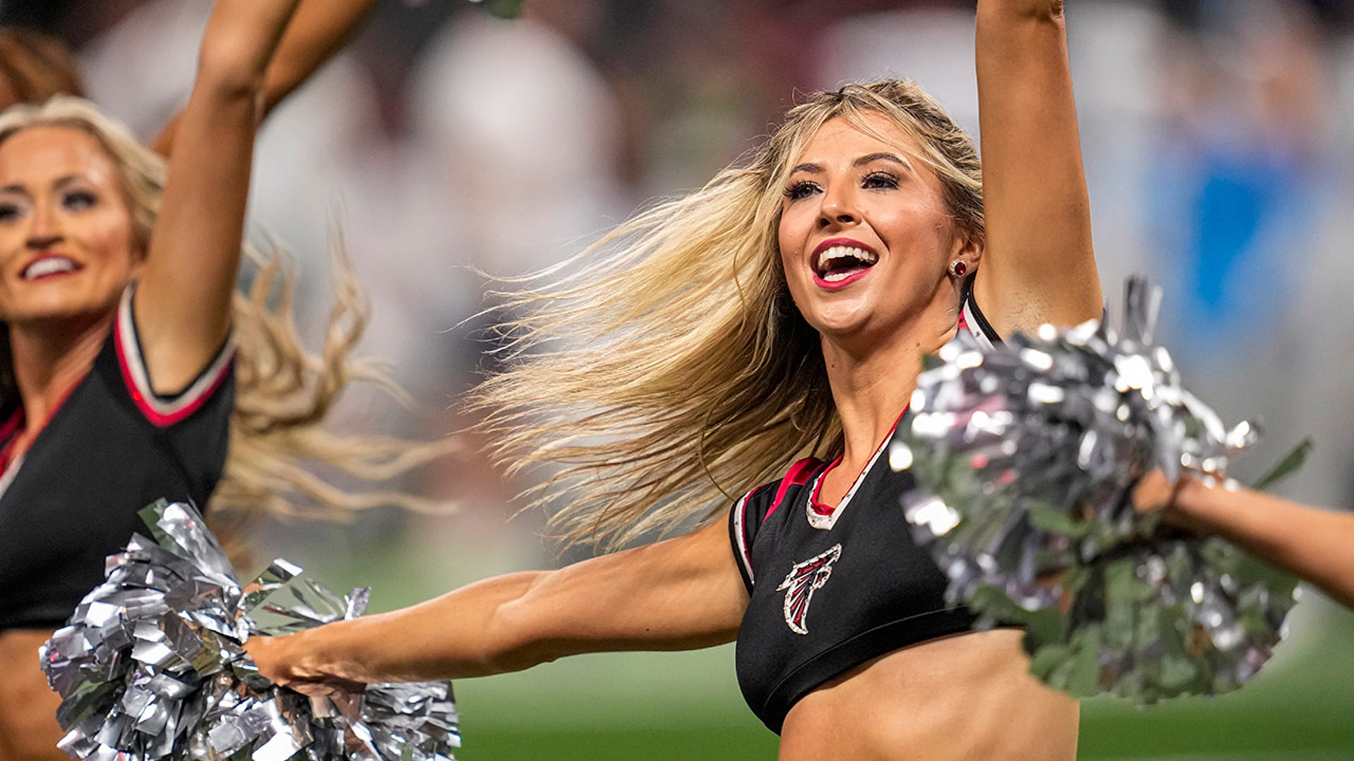 A cheerleader mid-cheer