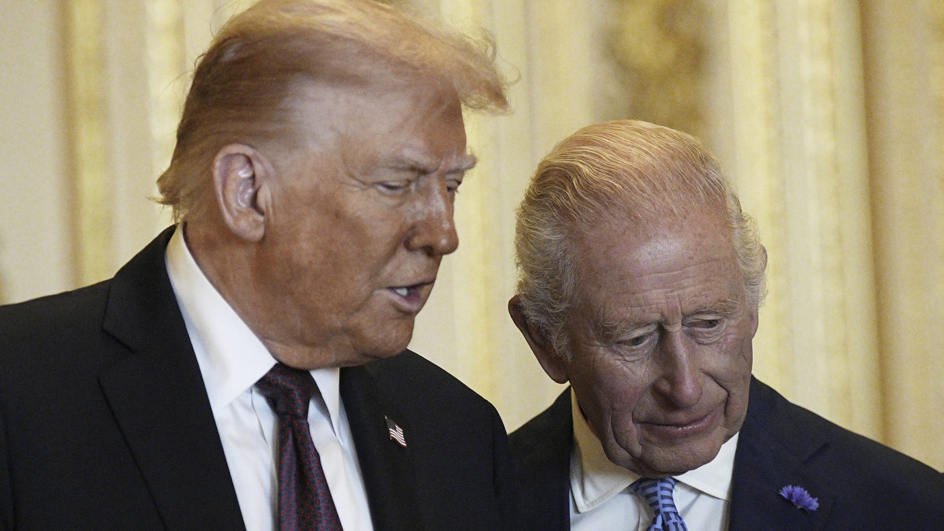 President Donald Trump and King Charles III examine historical items in the Green Drawing Room at Windsor Castle.