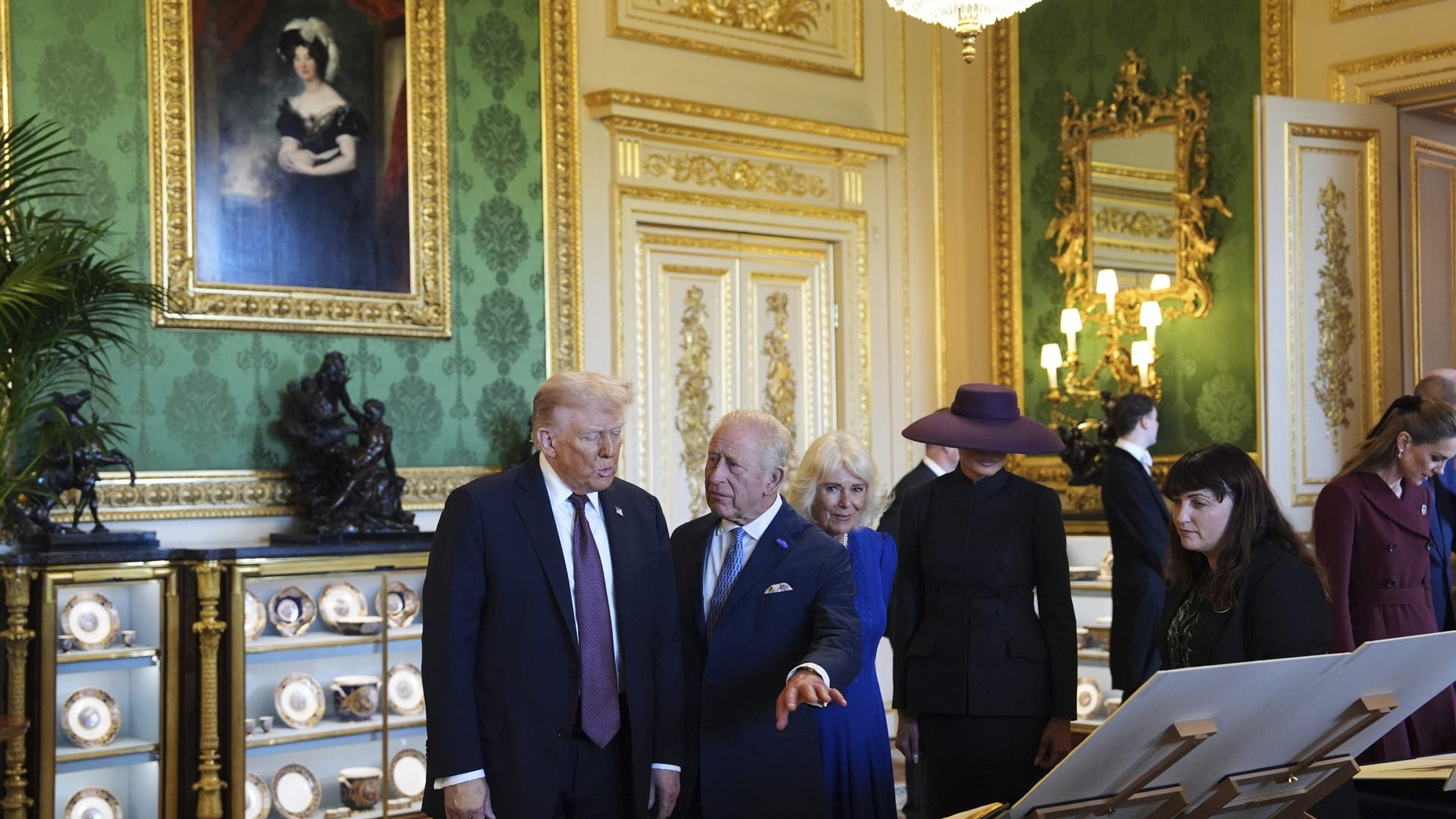 President Donald Trump, first lady Melania Trump, King Charles III, and Queen Camilla observe a special exhibition of US-related items.