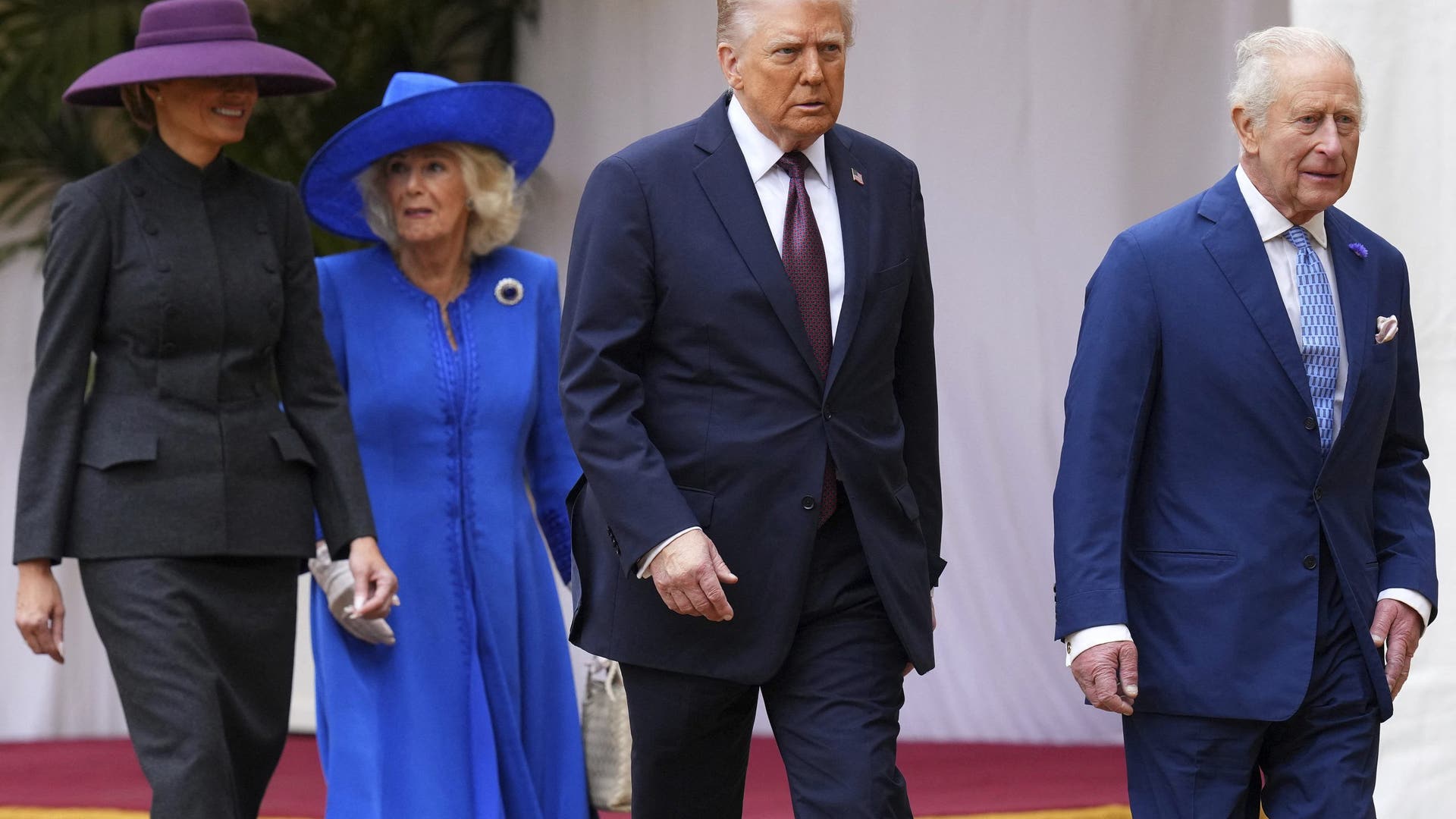 Melania Trump, President Donald Trump, King Charles III, and Queen Camilla walk away from the dias during a ceremonial welcome at Windsor Castle.