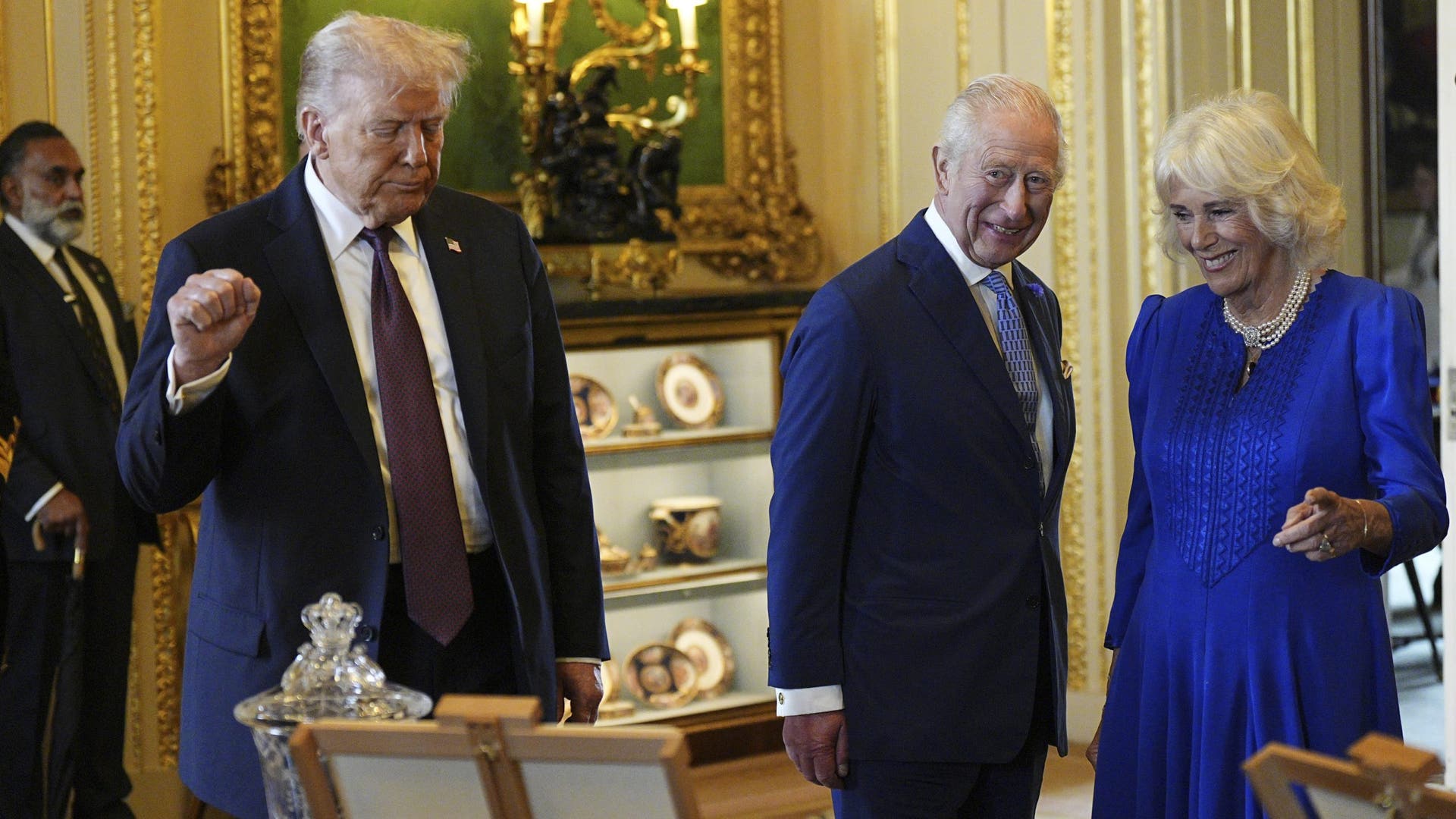 President Donald Trump, King Charles III, and Queen Camilla view items from the Royal Collection exhibition in the Green Drawing Room at Windsor Castle.