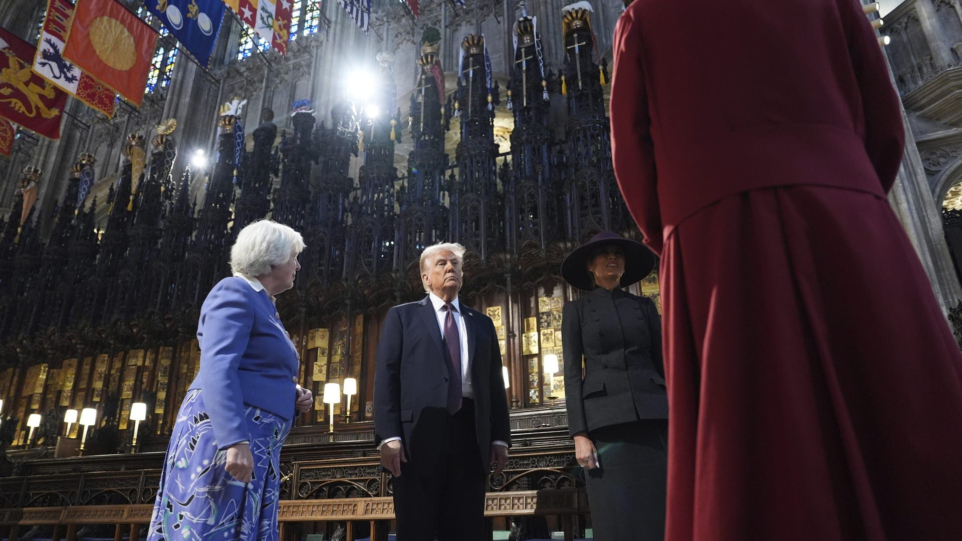 Trump and Melania with stained glass and flags overhead