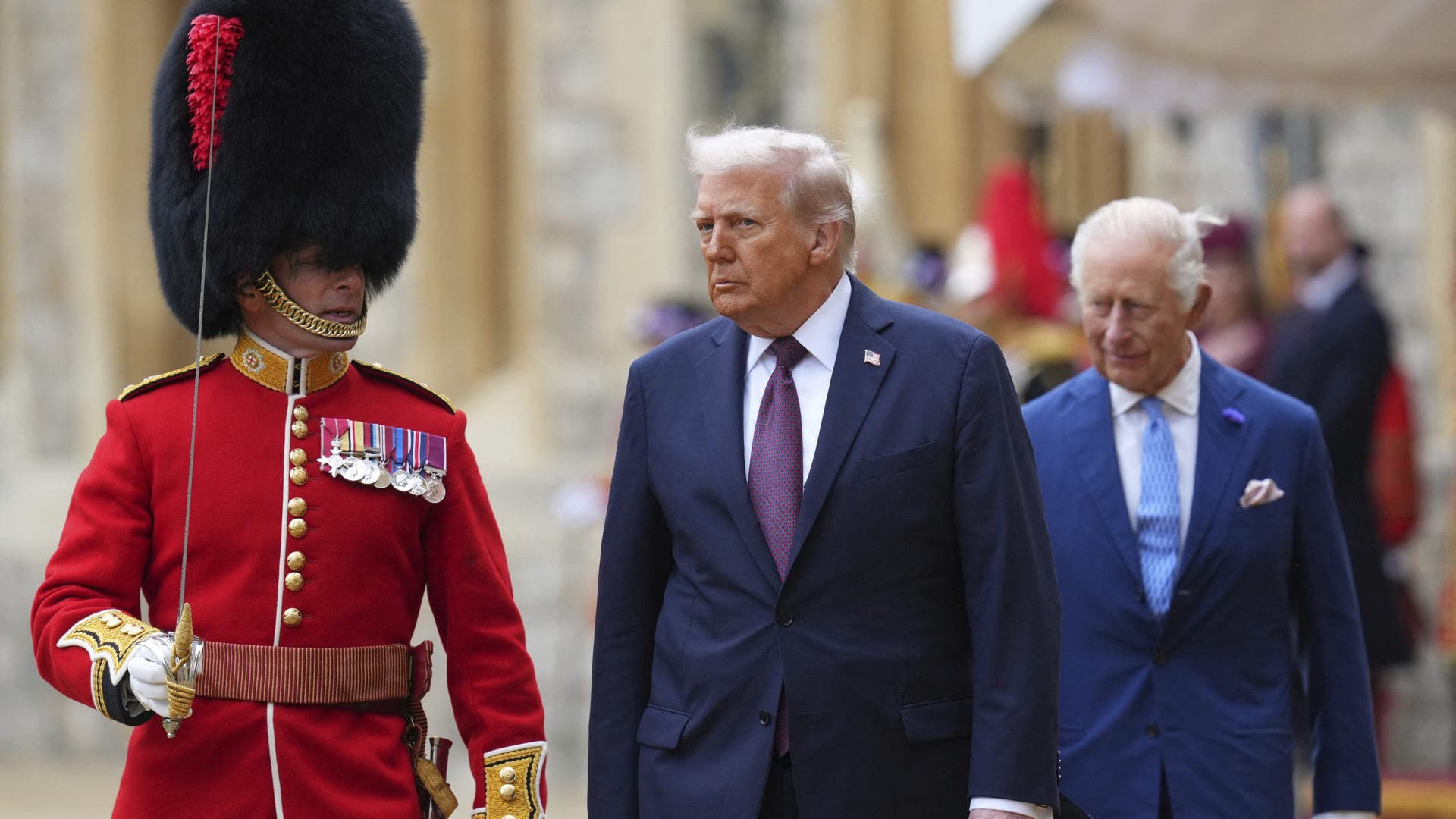 US President Donald Trump and King Charles III walk to inspect the Guard of Honour during the ceremonial welcome at Windsor Castle.