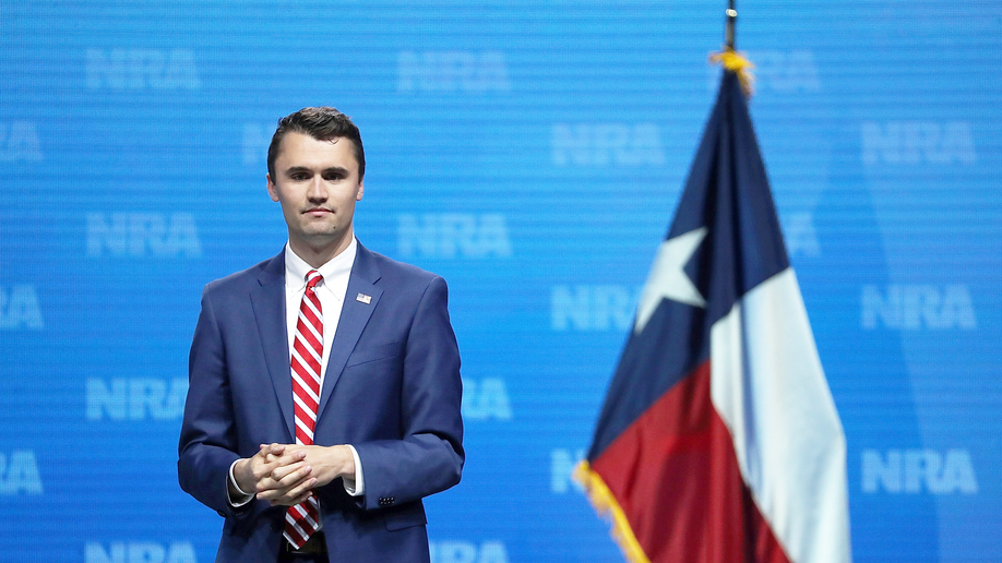 Charlie Kirk on stage at an NRA event