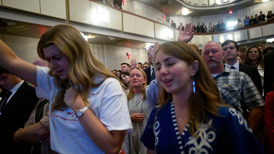 People sing and pray during Charlie Kirk vigil