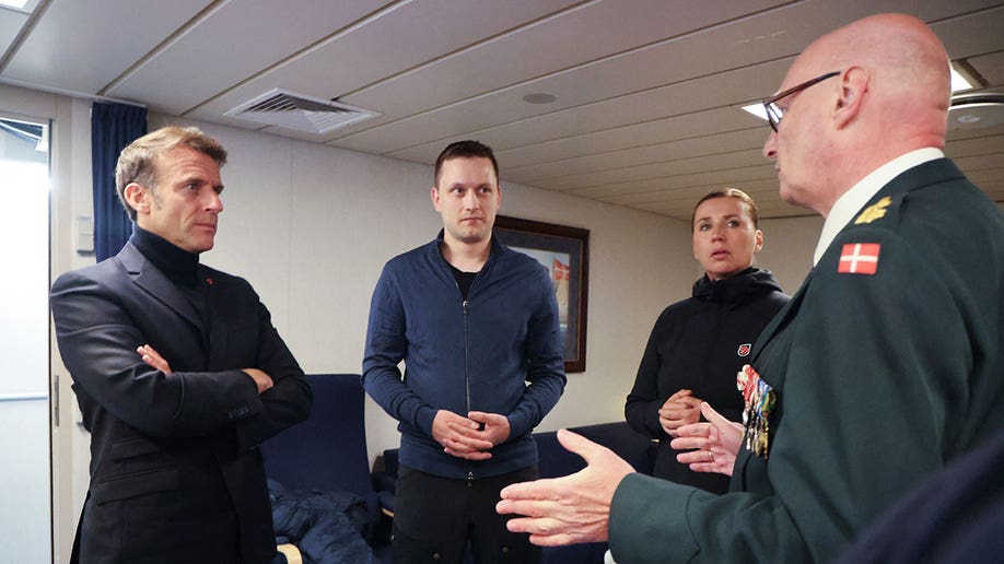 Macron stands with other officials in Greenland
