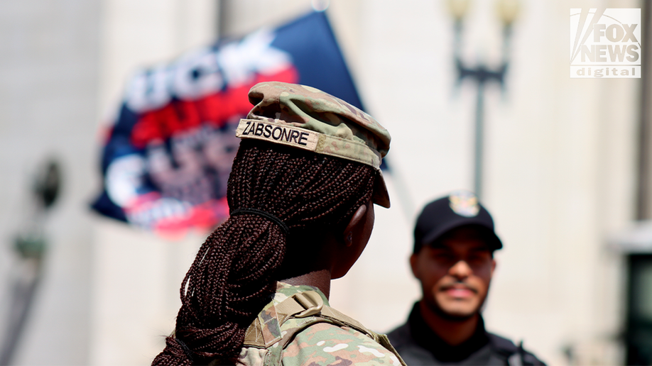 national guard stands amongst protesters