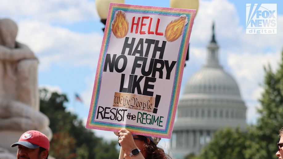 protest signs in front of capitol building