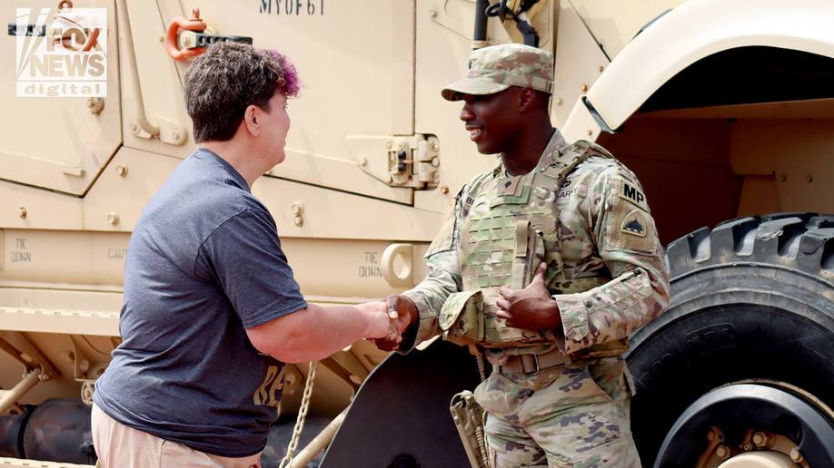 veteran shakes hands with national guard